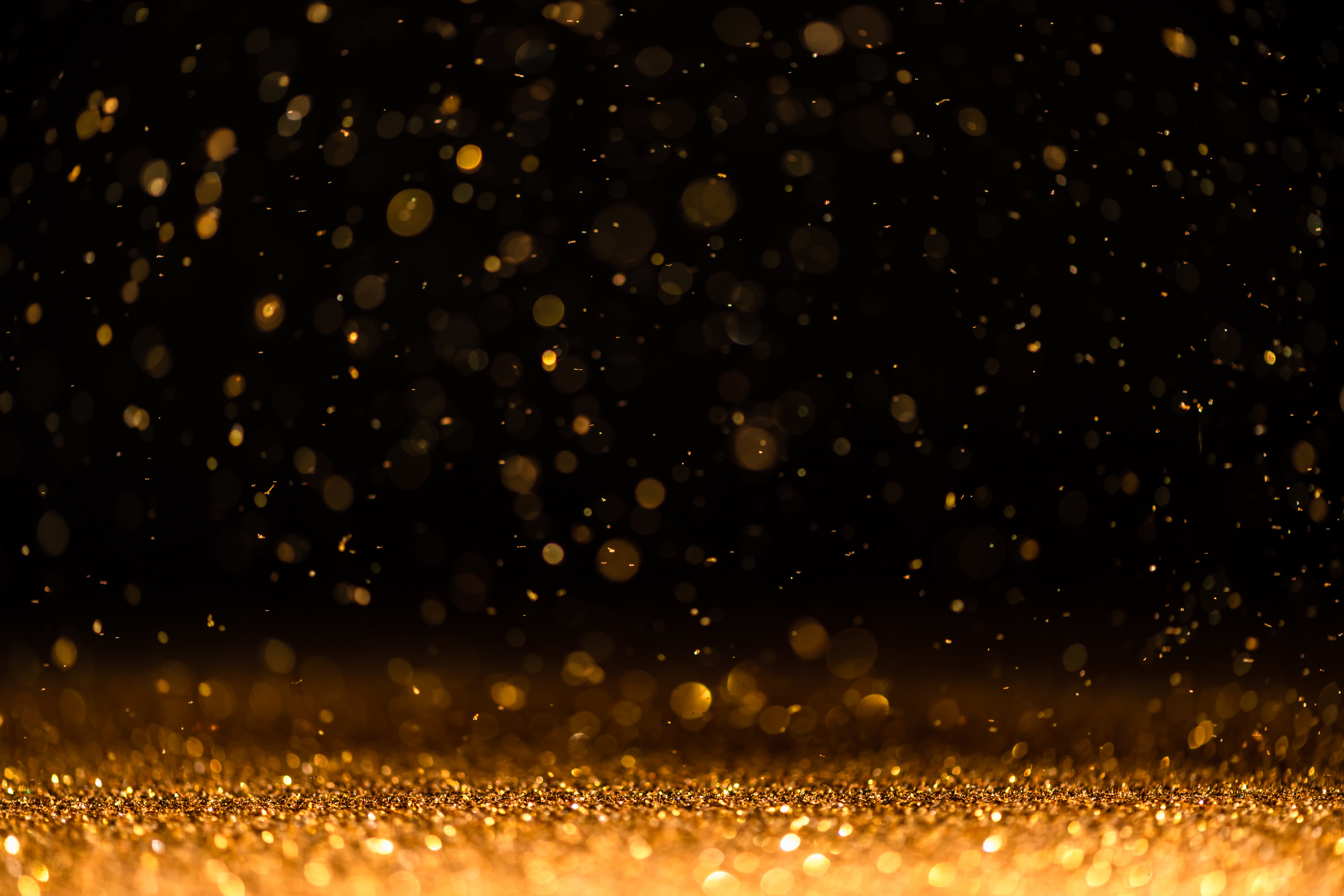 Gold Sequins Fall on a Black Background